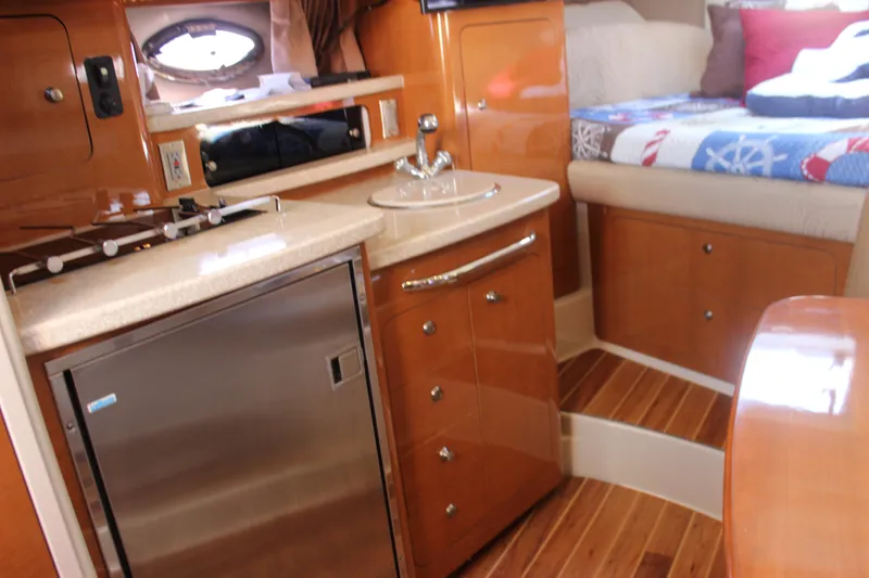 Slide: The Image of 2007 Chaparral Signature 310 interior with kitchenette, sink, and cozy sleeping area. - 18