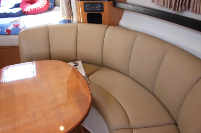 Slide: The Image of 2007 Chaparral Signature 310 interior with beige leather seating and wooden table. - 20