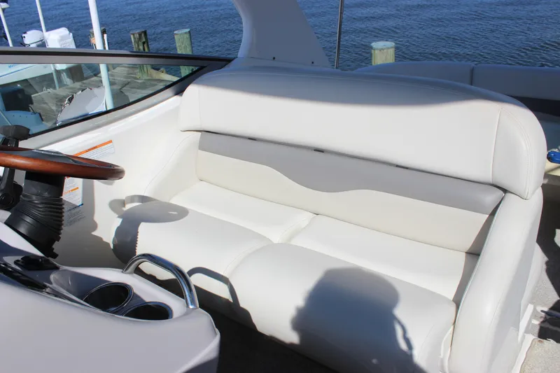 Slide: The Image of 2007 Chaparral Signature 310 boat interior with white seating and wooden steering wheel. - 27