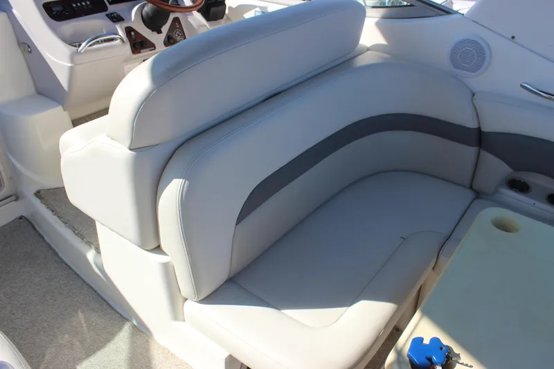 Slide: The Image of 2007 Chaparral Signature 310 boat interior with cushioned seating and steering wheel. - 28