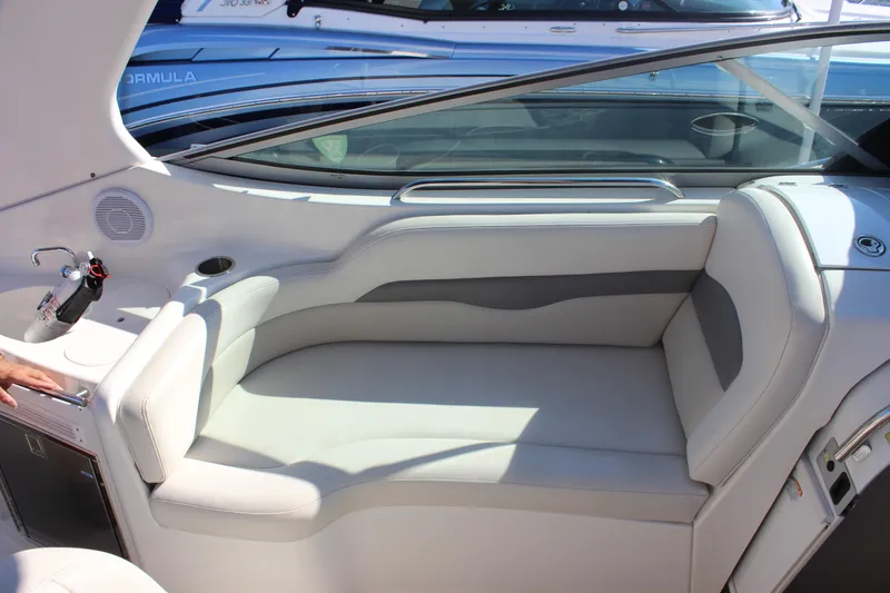 Slide: The Image of 2007 Chaparral Signature 310 boat interior with white seating and built-in amenities. - 32