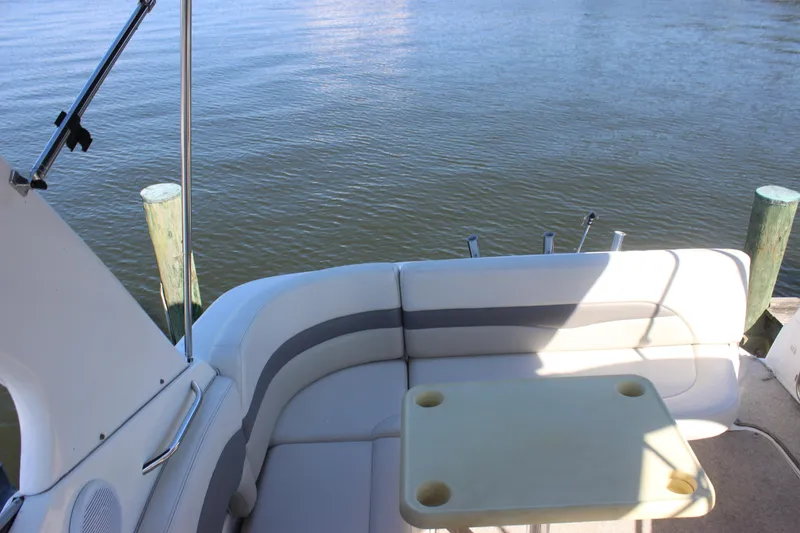 Slide: The Image of 2007 Chaparral Signature 310 boat interior with seating and table by the water. - 35