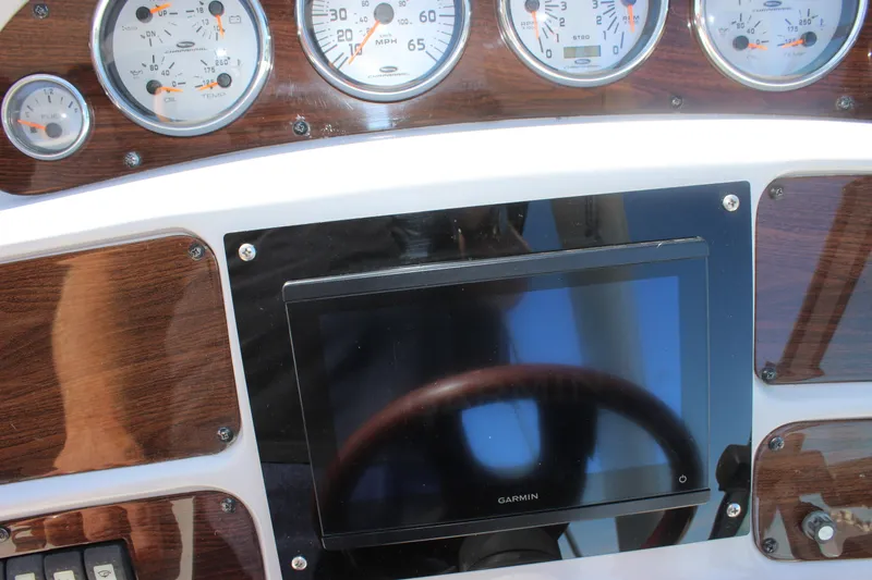 Slide: The Image of Dashboard of a 2007 Chaparral Signature 310 with gauges and Garmin display. - 36