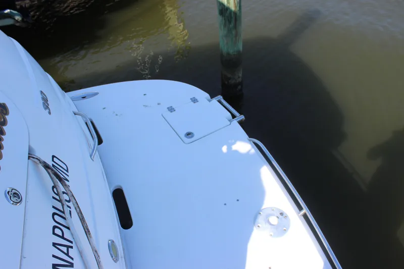 Slide: The Image of 2007 Chaparral Signature 310 boat stern near dock, showing swim platform and water. - 41