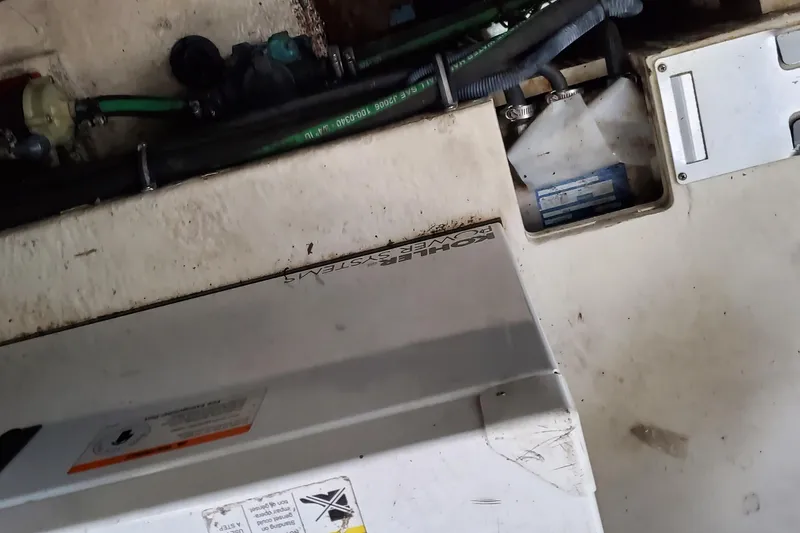 Slide: The Image of Engine compartment of a 2007 Chaparral Signature 310 boat, showing hoses and components. - 44