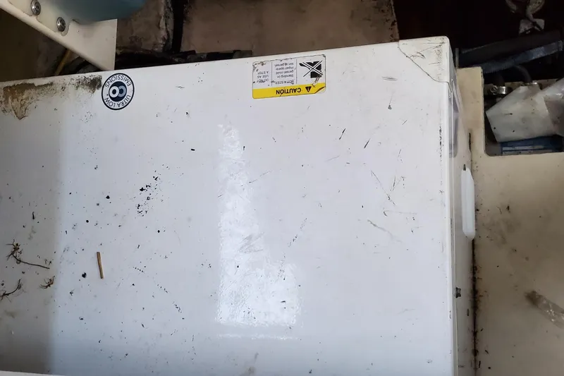 Slide: The Image of 2007 Chaparral Signature 310 boat interior with a white, slightly worn surface. - 45