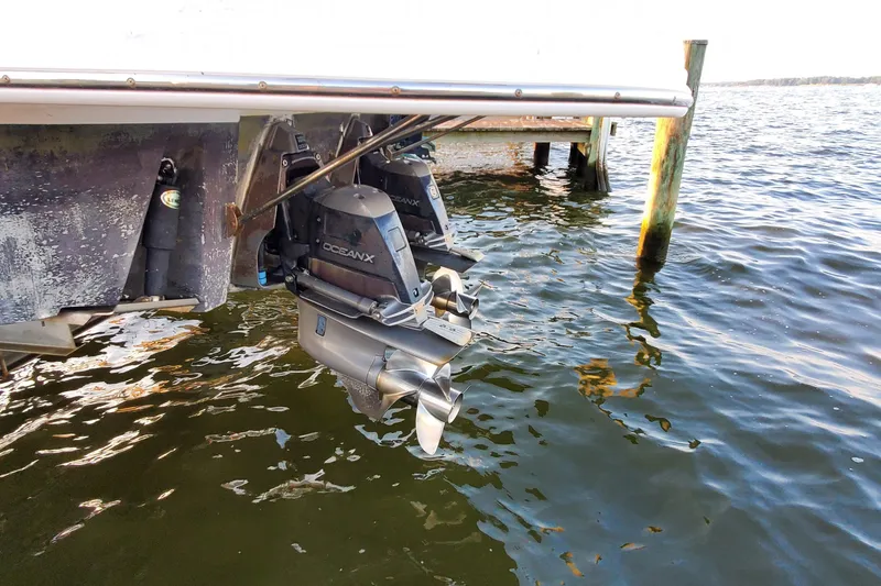 Slide: The Image of 2007 Chaparral Signature 310 boat engines above water at a dock. - 48