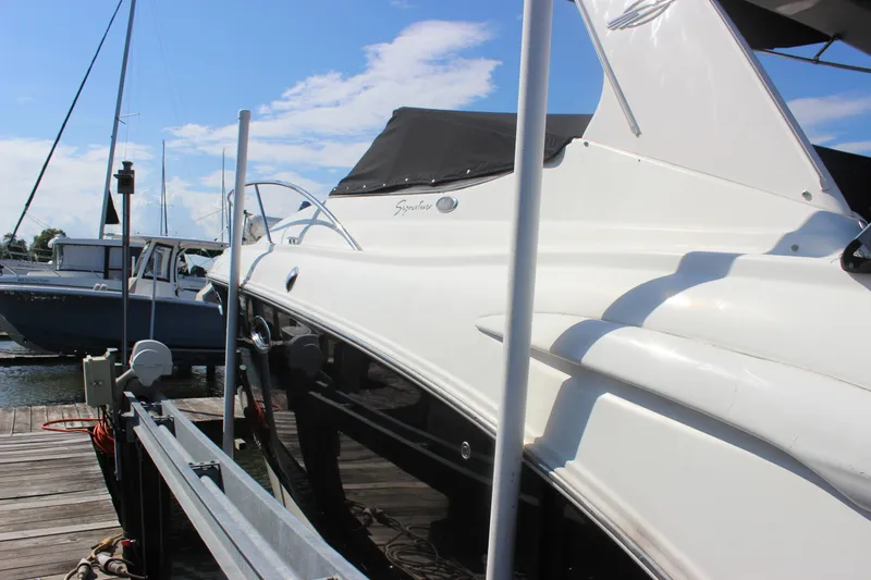 Slide: The Image of 2007 Chaparral Signature 310 boat docked at marina under clear blue sky. - 7
