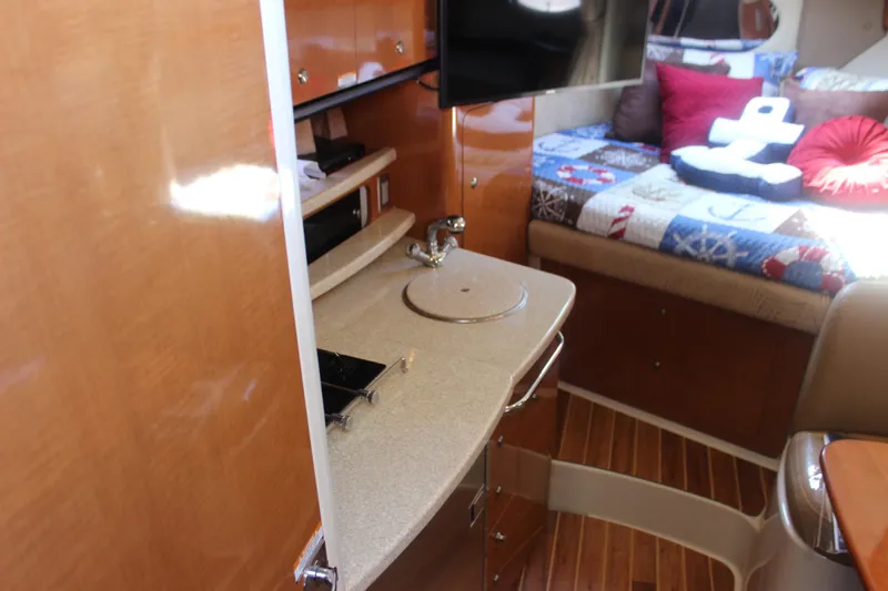 Slide: The Image of 2007 Chaparral Signature 310 interior with kitchenette and cozy seating area. - 8