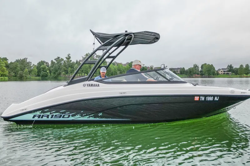 The Image of 2023 Yamaha Boats AR190 on a serene lake with lush greenery. - 0