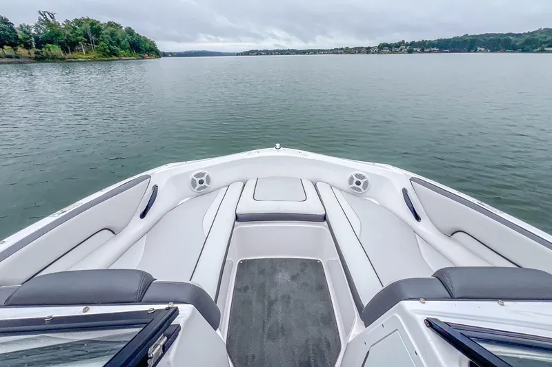 Slide: The Image of 2023 Yamaha Boats AR190 on calm lake, featuring spacious seating and scenic view. - 11