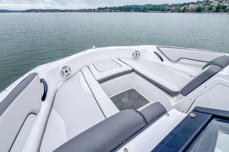 Slide: The Image of 2023 Yamaha Boats AR190 interior with sleek seating on a calm lake. - 12