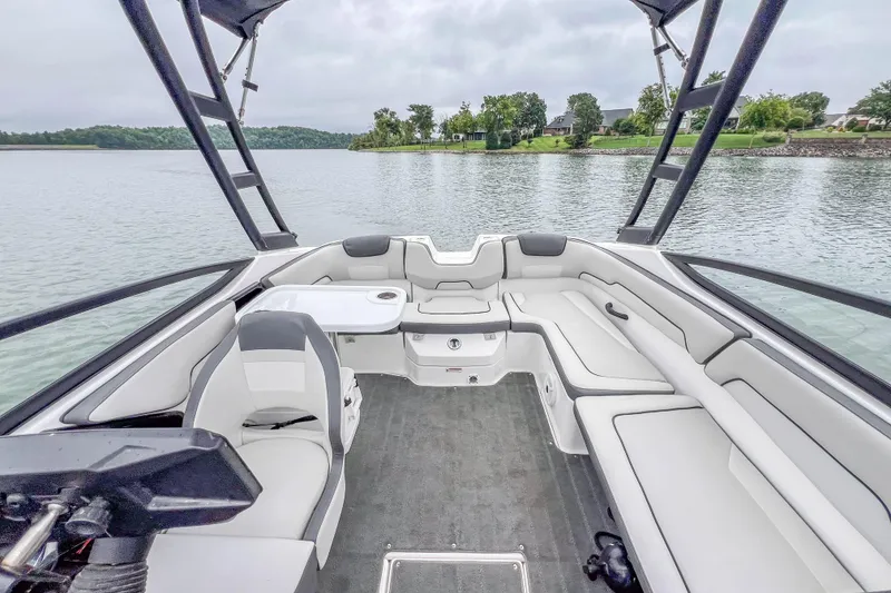 Slide: The Image of 2023 Yamaha Boats AR190 interior with sleek seating and lake view. - 13
