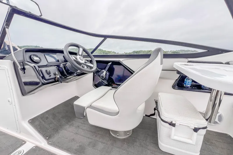 Slide: The Image of 2023 Yamaha Boats AR190 cockpit with steering wheel and seating, showcasing modern design. - 15