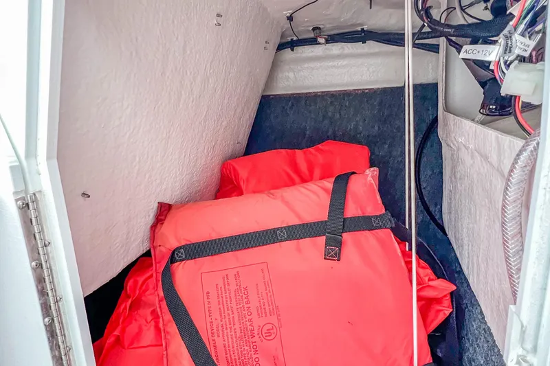 Slide: The Image of 2023 Yamaha AR190 storage compartment with life jackets and wiring. - 25