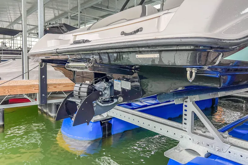 Slide: The Image of 2023 Yamaha Boats AR190 on lift, showcasing hull and propulsion system. - 32