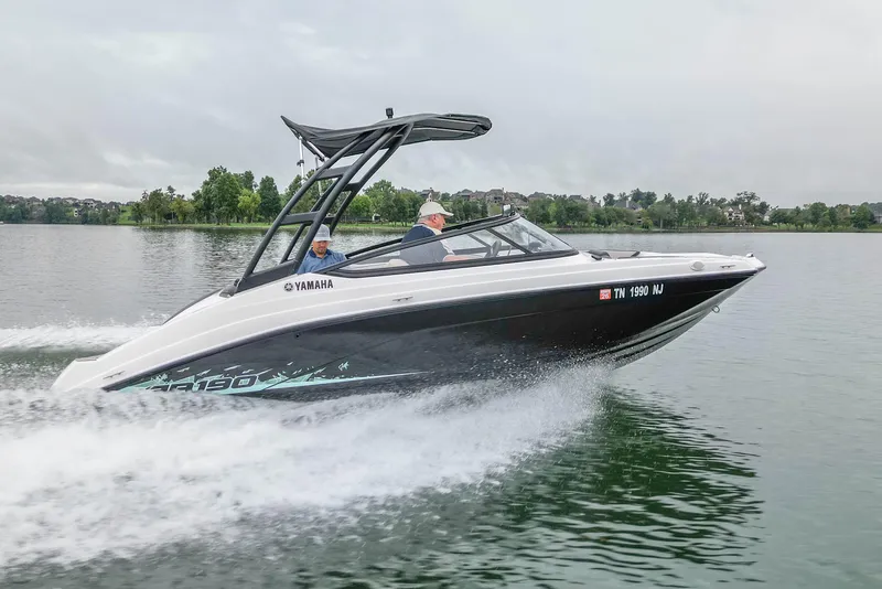 Slide: The Image of 2023 Yamaha AR190 boat cruising on a lake with two passengers. - 5