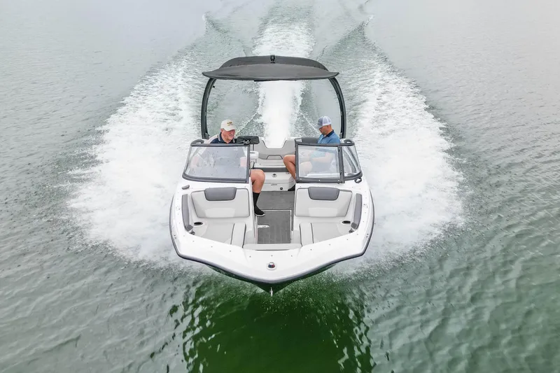 Slide: The Image of 2023 Yamaha Boats AR190 speeding on water, two passengers enjoying the ride. - 7