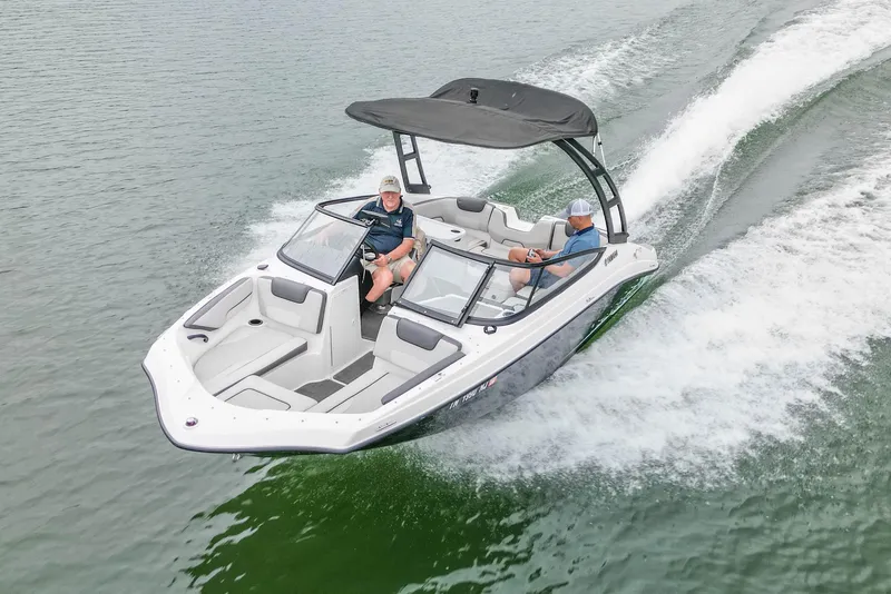 Slide: The Image of 2023 Yamaha Boats AR190 cruising on water with two passengers onboard. - 8