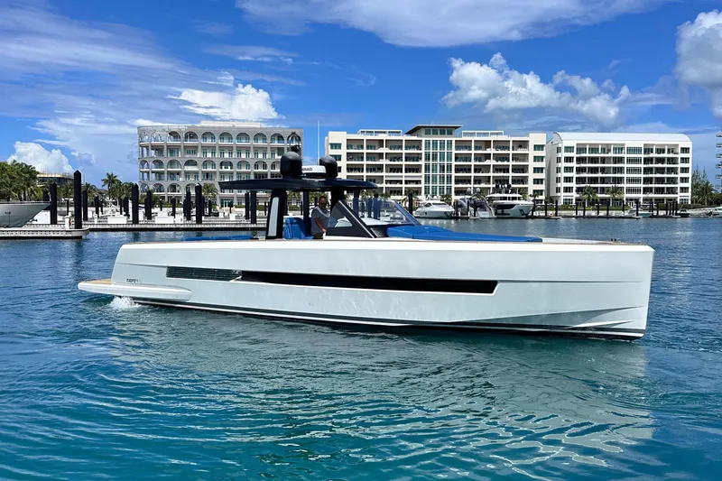 The Image of 2020 Fjord 44 Open yacht cruising in a marina with modern buildings in the background. - 1