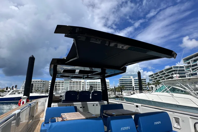 Slide: The Image of 2020 Fjord 44 Open yacht with sleek design docked at marina under blue sky. - 16