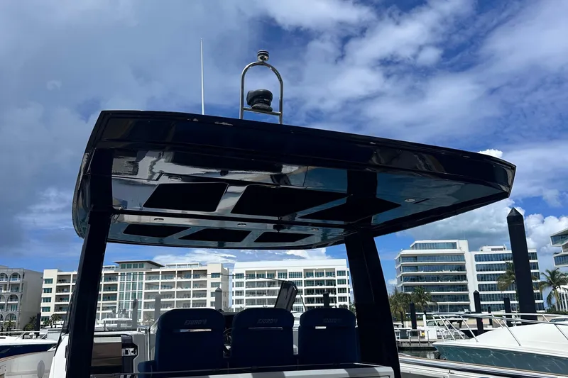 Slide: The Image of 2020 Fjord 44 Open yacht with sleek design, docked at marina under blue sky. - 17