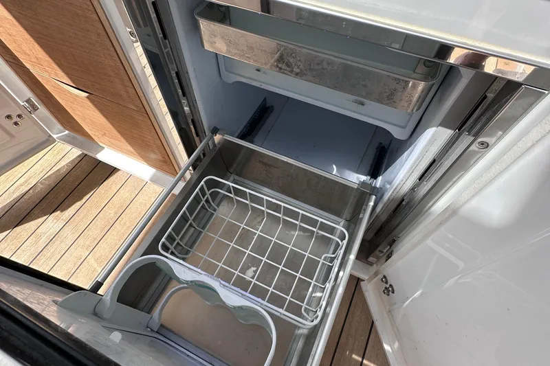 Slide: The Image of Open drawer on 2020 Fjord 44 Open yacht, showcasing storage space and wooden flooring. - 22