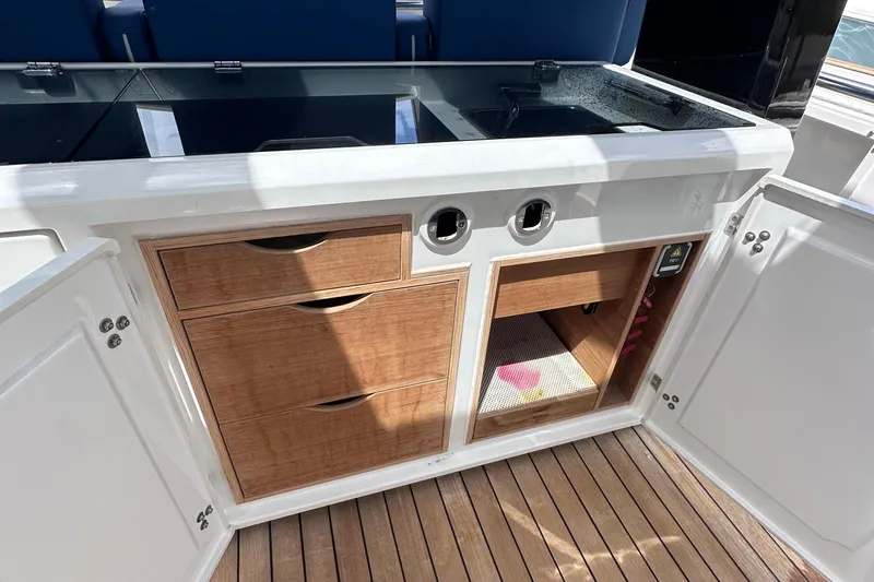 Slide: The Image of Interior of 2020 Fjord 44 Open yacht with wooden cabinetry and storage compartments. - 23