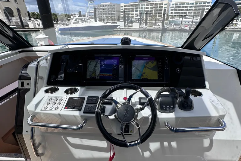 Slide: The Image of Cockpit of 2020 Fjord 44 Open yacht with navigation screens and controls. - 25