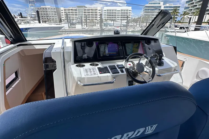 Slide: The Image of Cockpit view of 2020 Fjord 44 Open yacht with modern controls and marina backdrop. - 26