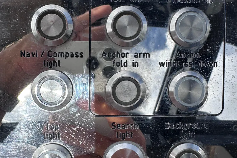 Slide: The Image of Control panel of a 2020 Fjord 44 Open boat with labeled buttons. - 27
