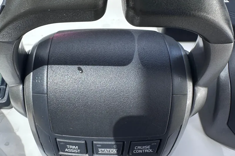 Slide: The Image of Close-up of 2020 Fjord 44 Open boat controls with trim assist and cruise control buttons. - 32