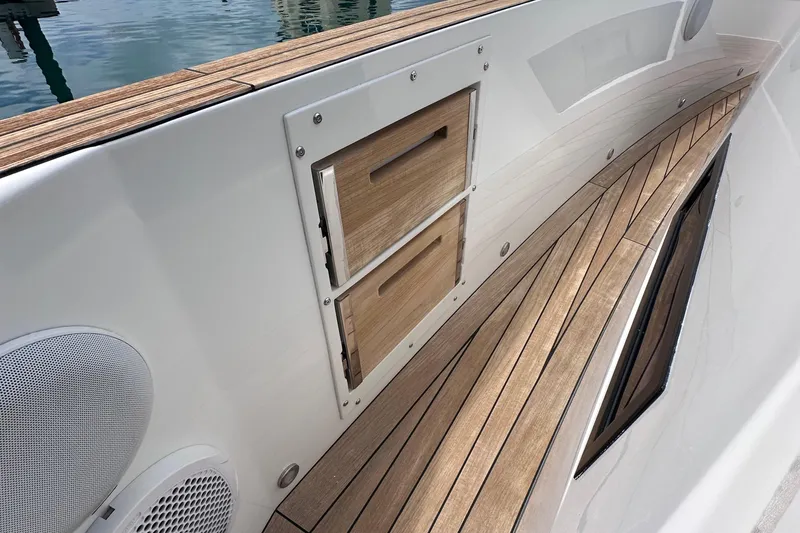 Slide: The Image of 2020 Fjord 44 Open yacht deck with wooden flooring and storage compartments. - 39