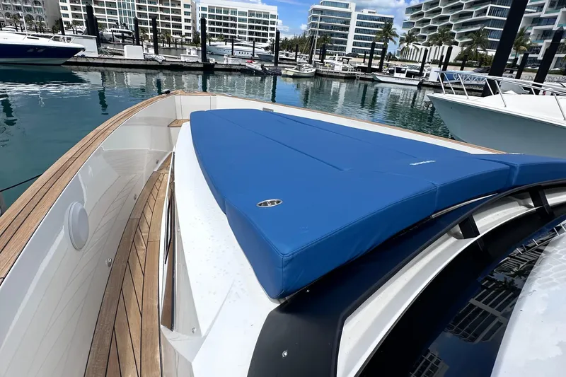 Slide: The Image of 2020 Fjord 44 Open yacht with blue sunbed, docked in a modern marina. - 41