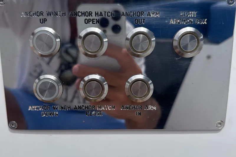 Slide: The Image of Control panel with buttons for anchor operations on a 2020 Fjord 44 Open boat. - 43