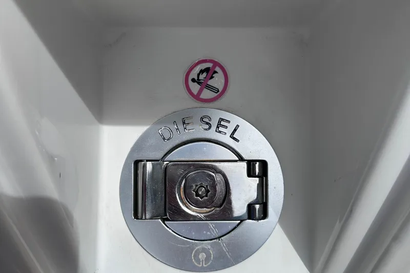 Slide: The Image of Diesel fuel cap on 2020 Fjord 44 Open boat with no smoking sign. - 48