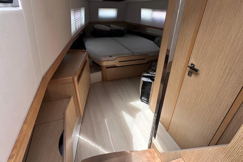 Slide: The Image of Interior of 2020 Fjord 44 Open yacht cabin with modern wood finish. - 50