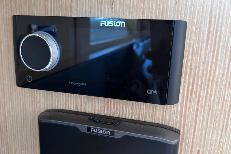 Slide: The Image of Fusion audio system on a 2020 Fjord 44 Open yacht, featuring WiFi and SiriusXM capabilities. - 53