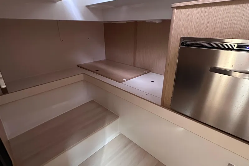 Slide: The Image of Interior of 2020 Fjord 44 Open yacht, featuring sleek wood finishes and compact design. - 58