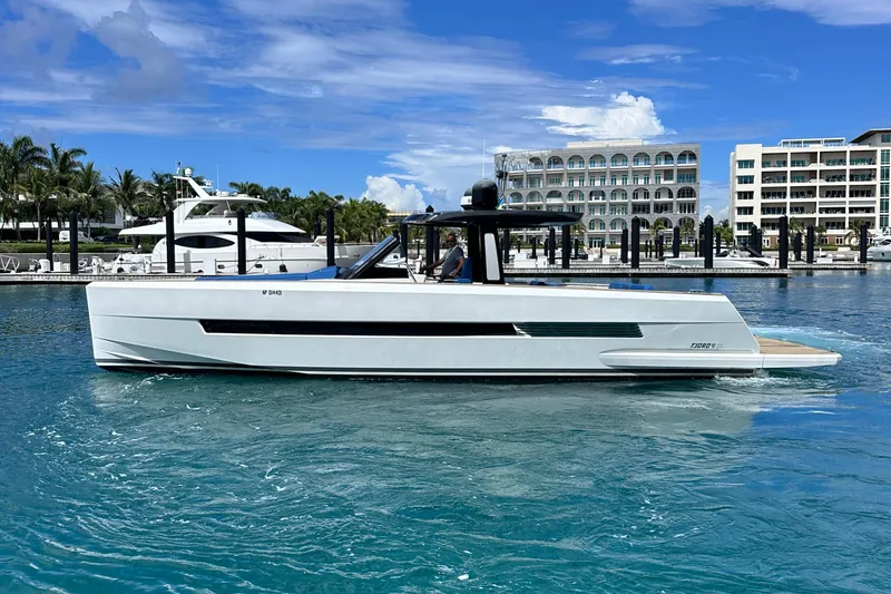 Slide: The Image of 2020 Fjord 44 Open yacht cruising in a marina with modern buildings in the background. - 6