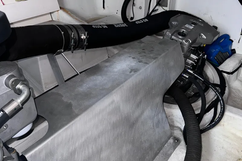 Slide: The Image of Engine compartment of a 2020 Fjord 44 Open boat, showcasing mechanical components and hoses. - 65