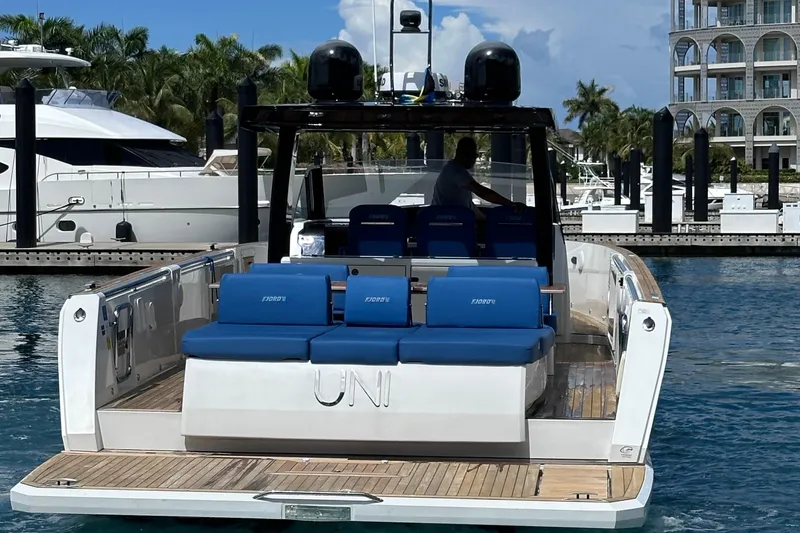 Slide: The Image of 2020 Fjord 44 Open yacht docked, featuring blue seating and modern design. - 9