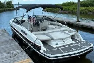 Slide: The Image of 2014 Larson LXi 258 IO boat docked with canopy and American flag. - 3