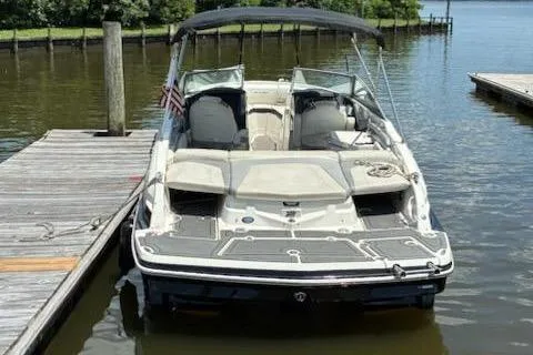 Slide: The Image of 2014 Larson LXi 258 IO boat docked on calm water with canopy. - 5