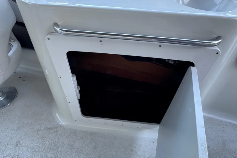 Slide: The Image of 2002 Crownline 239 DB boat interior with cushioned seating and water view. - 12