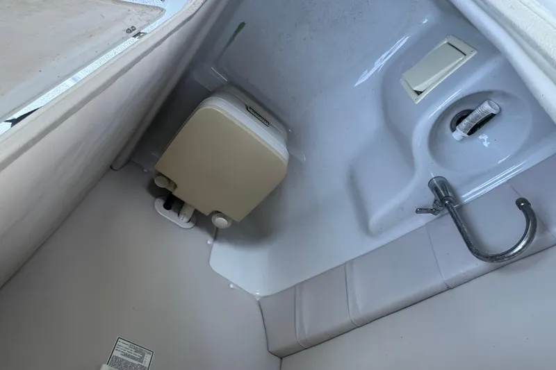 Slide: The Image of Bow view of 2002 Crownline 239 DB boat on water, featuring sleek design and seating. - 14