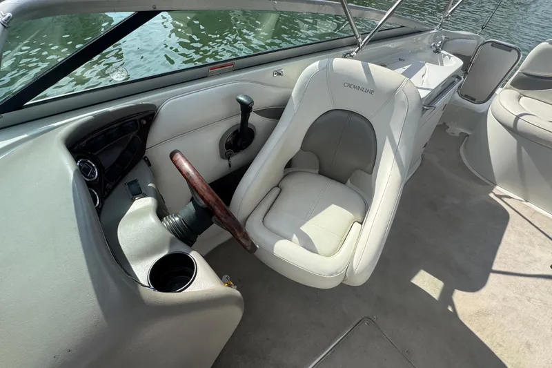 Slide: The Image of 2002 Crownline 239 DB boat interior with steering wheel and seating. - 16