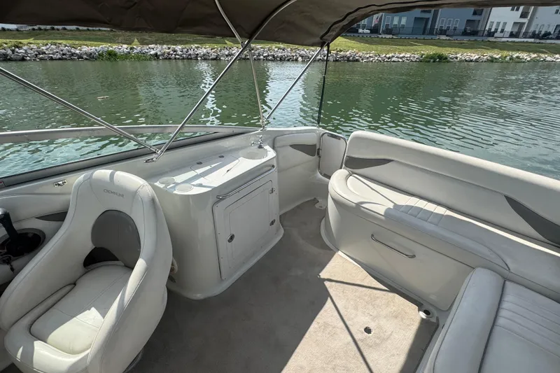 Slide: The Image of 2002 Crownline 239 DB boat interior with seating and water view. - 21