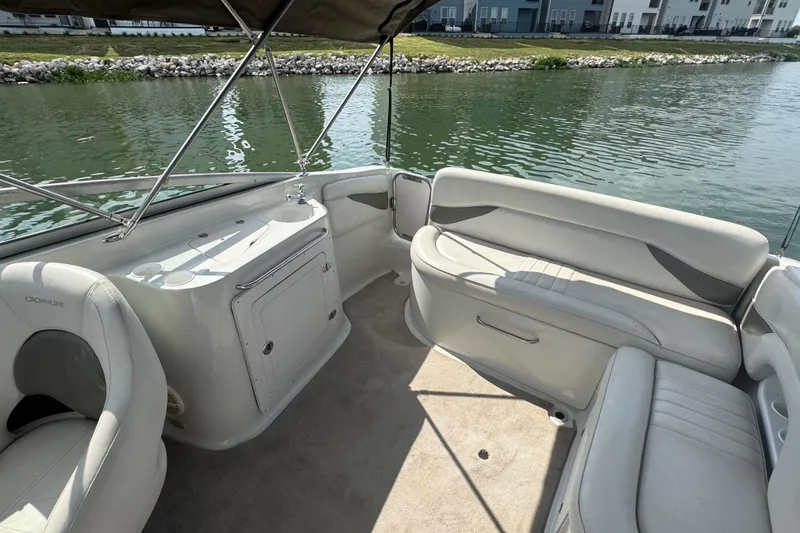 Slide: The Image of 2002 Crownline 239 DB boat interior with seating and water view. - 22