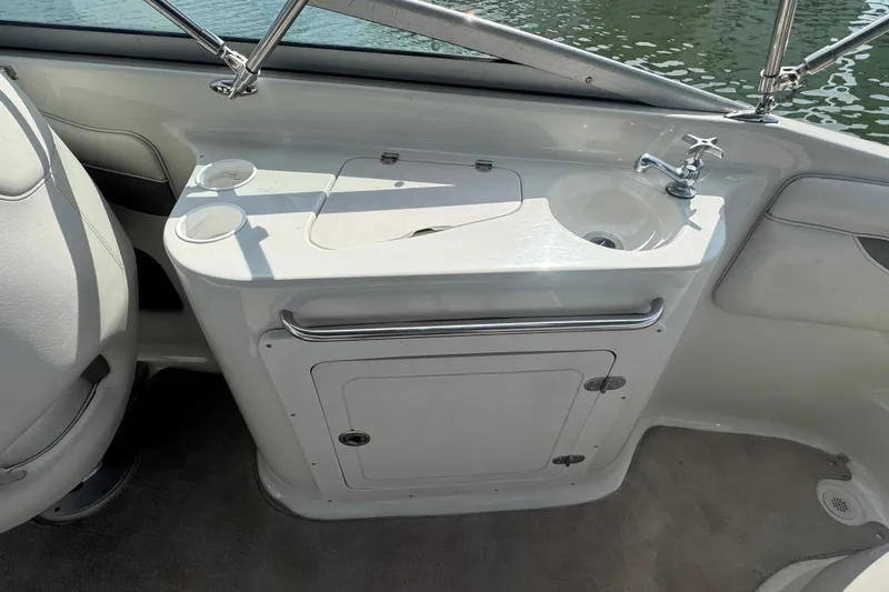 Slide: The Image of 2002 Crownline 239 DB boat interior with sink and storage compartment. - 24